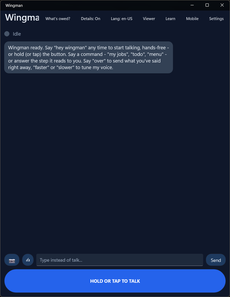 The Wingman client, idle and ready: 'Say hey wingman any time to start talking, hands-free - or hold (or tap) the button. Say a command - my jobs, todo, menu - or answer the step it reads to you. Say over to send what you've said right away, faster or slower to tune my voice.' A What's owed? control sits in the top bar, and a box to type instead of talk sits above the big HOLD OR TAP TO TALK button.